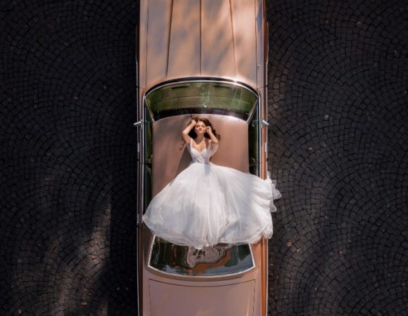 aerial view elegant bride lying roof pink retro car min