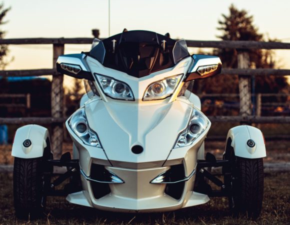 beautiful shot silver sports quad bike field front wooden fence 1 scaled 1