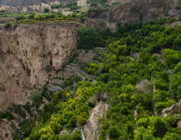 bird eye shot huge picturesque mountains cliffs partly covered green trees